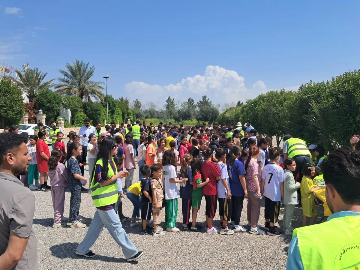 A large group of children and adults gathered outdoors for the Family Run.